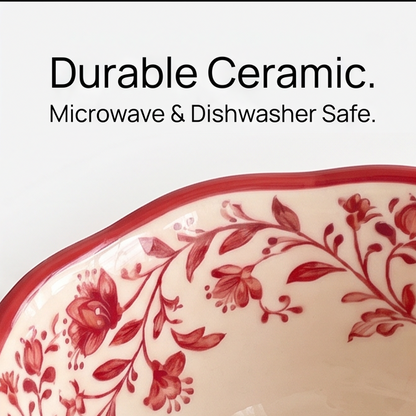 Close-up of the red wavy rim and floral exterior on cream ceramic bowl