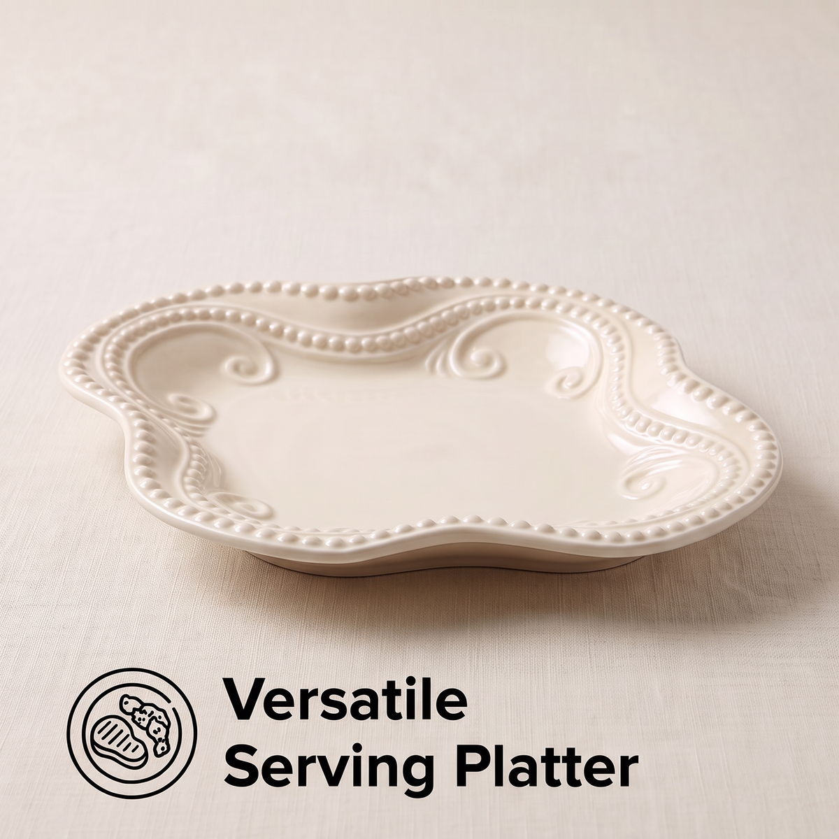 Ivory ceramic serving platter with a scalloped outline and raised beaded scrollwork rim, angled product view