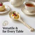 Cream twisted-handle ceramic spoon resting in a cup of coffee