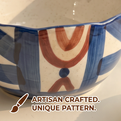 Close-up of blue and terracotta abstract pattern on stoneware bowl exterior