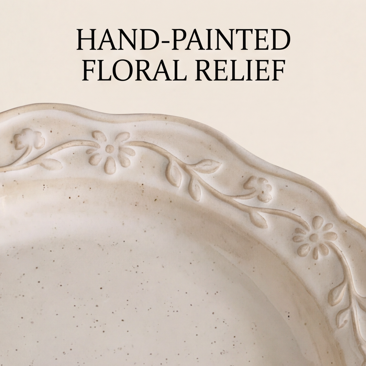 Floral relief stoneware plate holding brunch food at a table