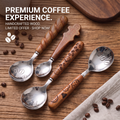 Four walnut-handle coffee spoons with different designs on a wooden table
