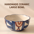 Top view of cream speckled interior and scalloped blue rim on large stoneware bowl