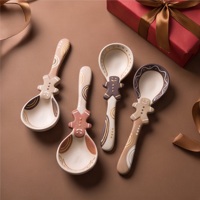Close-up of pink gingerbread figure on ceramic spoon showing painted smile and buttons