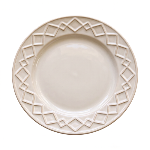 Cream serving plate with a raised geometric relief border, top-down view on a light background